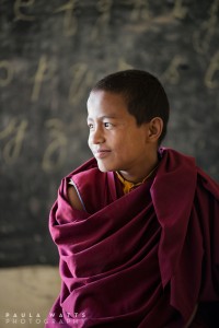 young Tibetan buddhist monk in classroom